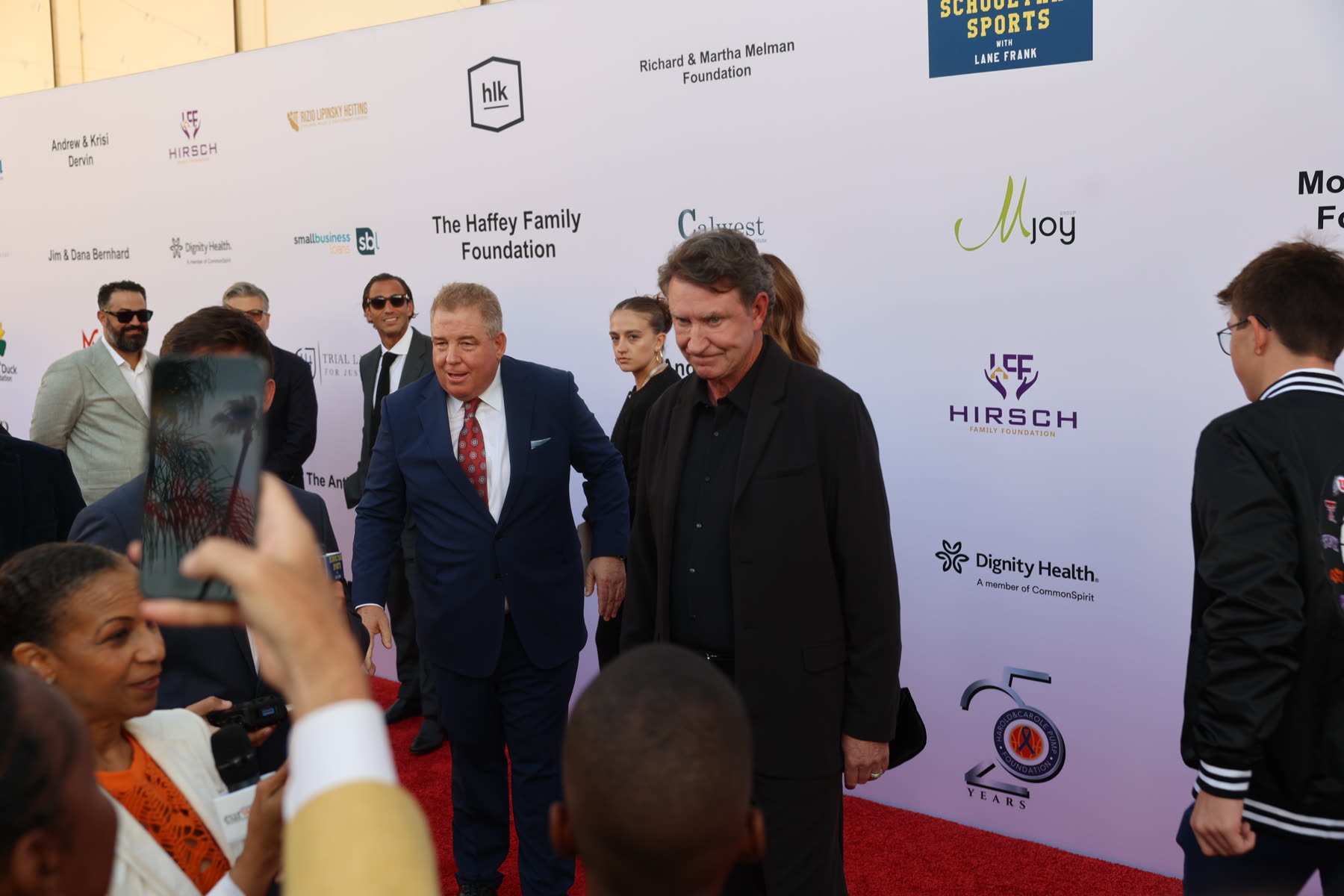 Guests arriving along the 25 Years sponsor wall
